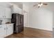 Bright kitchen with white cabinetry, stainless steel appliances, and wood flooring at 4232 N 112Th Ln, Phoenix, AZ 85037