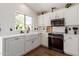 Bright kitchen with white cabinetry, farmhouse sink and stainless-steel appliances at 4232 N 112Th Ln, Phoenix, AZ 85037