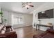 A spacious living room is filled with natural light, highlighting the beautiful flooring at 4232 N 112Th Ln, Phoenix, AZ 85037