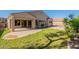 Lush backyard featuring green grass, a covered patio and pool area at 4356 E Carriage Way, Gilbert, AZ 85297