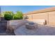 Backyard sitting area offers a custom-built fire pit and curved seating, perfect for cozy outdoor gatherings at 4356 E Carriage Way, Gilbert, AZ 85297