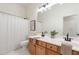 Neutral bathroom featuring a double sink vanity with a shower and curtain in the background at 4356 E Carriage Way, Gilbert, AZ 85297