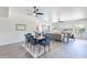 Open-concept dining area with modern light fixture, wood-look floors, and views of the living room at 4356 E Carriage Way, Gilbert, AZ 85297