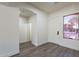 Inviting entryway with light gray wood flooring, white walls, and a view of the living spaces at 4356 E Carriage Way, Gilbert, AZ 85297