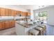 Kitchen with large island, seating, granite countertops, and pool views at 4356 E Carriage Way, Gilbert, AZ 85297
