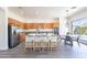 Kitchen island with bar seating, stainless steel appliances, and adjacent breakfast nook at 4356 E Carriage Way, Gilbert, AZ 85297