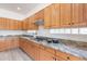 Stylish kitchen with granite countertops, tile backsplash, and wood cabinetry at 4356 E Carriage Way, Gilbert, AZ 85297