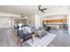 Open-concept living room connects to kitchen and dining, with hardwood floors and neutral colors at 4356 E Carriage Way, Gilbert, AZ 85297