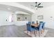 Open-concept living area with neutral paint, a modern light fixture, and views into the dining area at 4356 E Carriage Way, Gilbert, AZ 85297