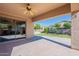 Spacious covered patio with a ceiling fan offering an open view of the expansive, well-maintained backyard at 4356 E Carriage Way, Gilbert, AZ 85297