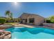 Resort-style backyard featuring a sparkling pool with rock features and a comfortable spa at 4356 E Carriage Way, Gilbert, AZ 85297