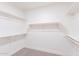 Spacious walk-in closet with ample shelving and rod space for organized storage at 4356 E Carriage Way, Gilbert, AZ 85297
