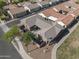 An aerial view of a landscaped home with paver patio, bordered by street and sidewalks at 4646 E Maplewood St, Gilbert, AZ 85297