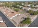 A high angle shot of a desert home and lush landscaping, with views of city landscape at 4646 E Maplewood St, Gilbert, AZ 85297