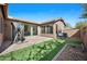 A private backyard featuring a paver patio, turf, and partial fencing at 4646 E Maplewood St, Gilbert, AZ 85297
