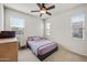 This bedroom has carpet and two windows for natural light at 4646 E Maplewood St, Gilbert, AZ 85297