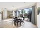 Bright dining area with a sliding glass door, tile flooring, and an open layout connecting to the living room at 4646 E Maplewood St, Gilbert, AZ 85297
