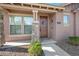 Inviting front entrance featuring a stone pillar, a wreath-adorned front door, and a well-maintained landscape at 4646 E Maplewood St, Gilbert, AZ 85297