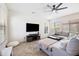 Bright living room with a ceiling fan, tile floors, a sectional sofa, and natural light from large windows at 4646 E Maplewood St, Gilbert, AZ 85297