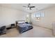 Spacious main bedroom with ample natural light, neutral carpet, a ceiling fan, and a serene atmosphere at 4646 E Maplewood St, Gilbert, AZ 85297