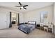 This spacious main bedroom features a ceiling fan, carpet and access to the main bath at 4646 E Maplewood St, Gilbert, AZ 85297