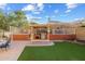 Well-equipped outdoor kitchen with pergola, BBQ, and ample counter space, nestled in a private backyard at 4715 E Carmen St, Phoenix, AZ 85044