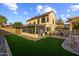 Spacious backyard featuring a pool, patio, seating and artificial grass, perfect for outdoor entertaining at 4715 E Carmen St, Phoenix, AZ 85044