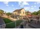 Spacious backyard with a screened porch, outdoor kitchen, and multi-level patio areas for entertaining at 4715 E Carmen St, Phoenix, AZ 85044