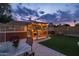 Beautiful backyard with a built-in grill area, lush greenery, and a comfortable seating area under a pergola at 4715 E Carmen St, Phoenix, AZ 85044
