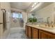 Bathroom featuring double sinks and a shower-tub combo, combining style and convenience at 4715 E Carmen St, Phoenix, AZ 85044