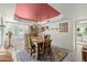 Traditional dining room features a red accent ceiling, area rug, and a large window that floods the space with natural light at 4715 E Carmen St, Phoenix, AZ 85044