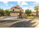 Charming two-story home with a well-manicured lawn and mature landscaping under a bright sky at 4715 E Carmen St, Phoenix, AZ 85044