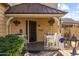 Cozy front porch with potted plants and seating, perfect for relaxing at 4715 E Carmen St, Phoenix, AZ 85044