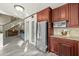 Well-lit kitchen features stainless steel appliances, tile flooring, wood cabinets, and easy access to the adjacent living space at 4715 E Carmen St, Phoenix, AZ 85044