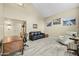 Bright living room features neutral walls, wood-look floors, vaulted ceiling, and ample space for relaxing and entertaining at 4715 E Carmen St, Phoenix, AZ 85044