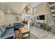 Spacious living room with vaulted ceilings, a decorative wood accent, and modern furnishings for a stylish and comfortable home at 4715 E Carmen St, Phoenix, AZ 85044