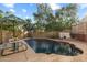 Private backyard pool with seating, patio, and block wall featuring a built-in basketball hoop at 4715 E Carmen St, Phoenix, AZ 85044