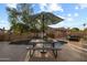 Inviting pool area featuring a dining set under a large umbrella, perfect for outdoor entertaining and relaxation at 4715 E Carmen St, Phoenix, AZ 85044