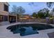 A serene backyard showcases a sparkling pool with an umbrella table, perfect for outdoor relaxation and entertaining at 4715 E Carmen St, Phoenix, AZ 85044