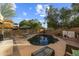 Spacious pool and patio area with a dining set, surrounded by greenery, perfect for summer relaxation at 4715 E Carmen St, Phoenix, AZ 85044