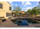 Backyard pool with tanning steps, a dining set, and a well-maintained patio area for leisure and recreation at 4715 E Carmen St, Phoenix, AZ 85044