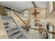 Bright, carpeted staircase with white railing connects multiple floors in this open-concept home design at 4715 E Carmen St, Phoenix, AZ 85044