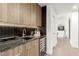 Wet bar with granite countertops, wine refrigerator, custom cabinets, and modern fixtures at 4835 E Onyx Ave, Paradise Valley, AZ 85253