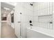 This bathroom features a soaking tub with vertical tiling and black hardware at 4835 E Onyx Ave, Paradise Valley, AZ 85253