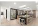 Open kitchen features a large island with bar seating, stainless steel appliances, and a pass-through window to the outside at 4835 E Onyx Ave, Paradise Valley, AZ 85253