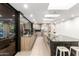Modern kitchen featuring a large island, stainless steel appliances, custom cabinets, and a pass-through window to the outdoor space at 4835 E Onyx Ave, Paradise Valley, AZ 85253