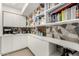 Walk-in pantry with custom cabinets, countertops, decorative tile backsplash, and ample storage space at 4835 E Onyx Ave, Paradise Valley, AZ 85253