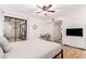 Serene bedroom with patio access, a ceiling fan, and a work space offering a peaceful retreat at 4950 N Miller Rd # 200, Scottsdale, AZ 85251