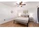 Cozy bedroom with wood floors, neutral decor, a ceiling fan, and bedside tables for a relaxing atmosphere at 4950 N Miller Rd # 200, Scottsdale, AZ 85251