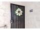 Front door with security screen and cheerful wreath for a welcoming entryway at 4950 N Miller Rd # 200, Scottsdale, AZ 85251
